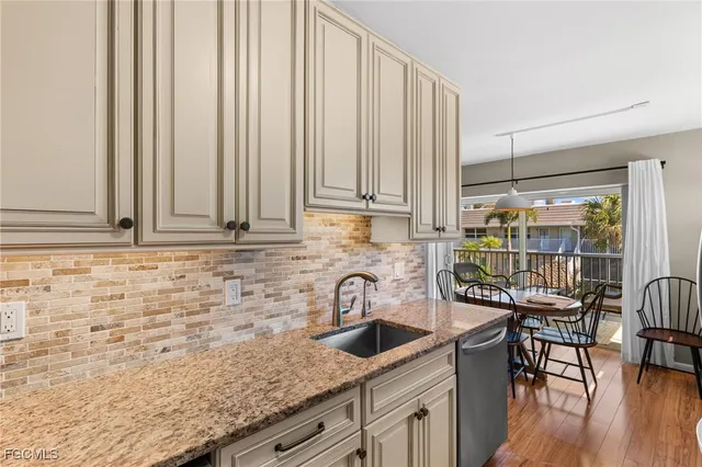 a kitchen with a refrigerator sink and cabinets