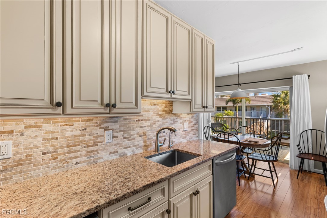 601 Periwinkle Way, Unit C5 Sanibel, FL 33957 - Photo 18 of 35 a kitchen with stainless steel appliances granite countertop a sink and a white cabinets