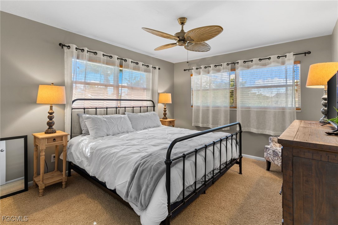 601 Periwinkle Way, Unit C5 Sanibel, FL 33957 - Photo 21 of 35 a bedroom with a bed and a chandelier