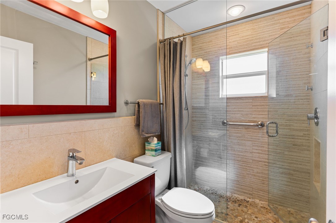 601 Periwinkle Way, Unit C5 Sanibel, FL 33957 - Photo 23 of 35 a bathroom with a sink a toilet and shower