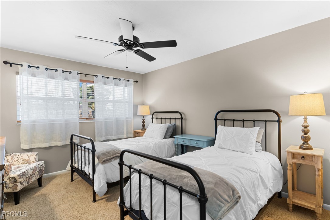 601 Periwinkle Way, Unit C5 Sanibel, FL 33957 - Photo 25 of 35 a bedroom with a bed and a chandelier