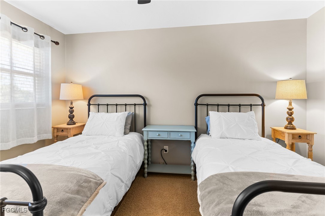 601 Periwinkle Way, Unit C5 Sanibel, FL 33957 - Photo 26 of 35 a bedroom with two beds and painting on the wall