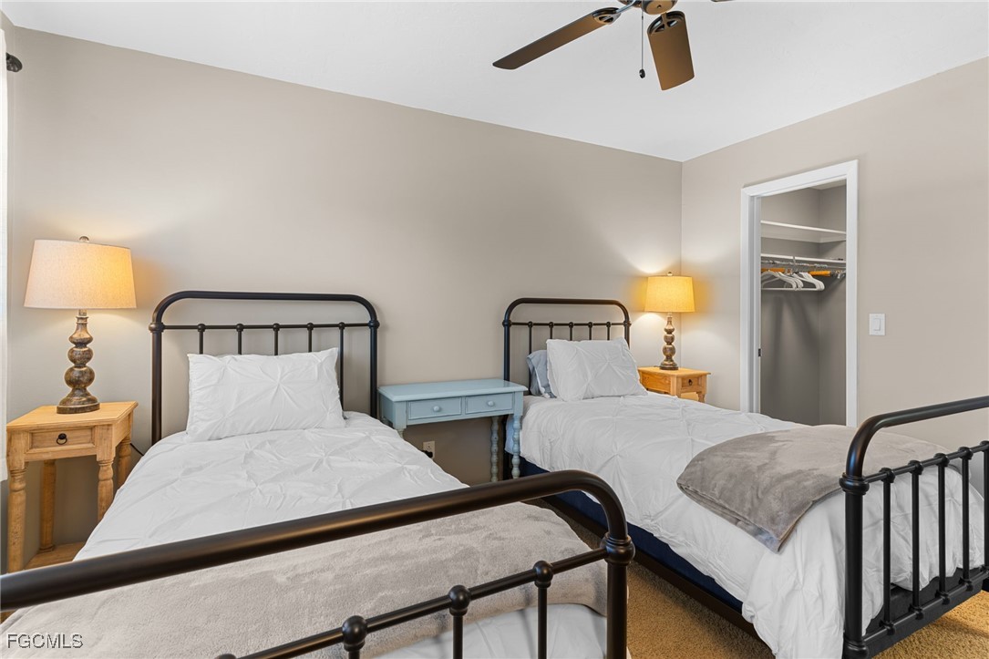 601 Periwinkle Way, Unit C5 Sanibel, FL 33957 - Photo 27 of 35 a bedroom with two beds and lamp