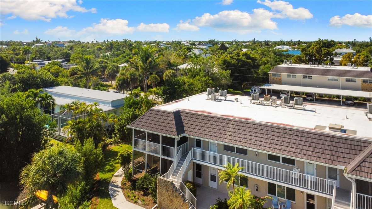 601 Periwinkle Way, Unit C5 Sanibel, FL 33957 - Photo 28 of 35 a view of a patio with swimming pool and city view