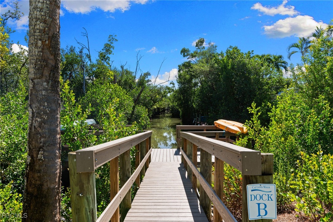 601 Periwinkle Way, Unit C5 Sanibel, FL 33957 - Photo 4 of 35 a balcony with wooden floor and yard in the back