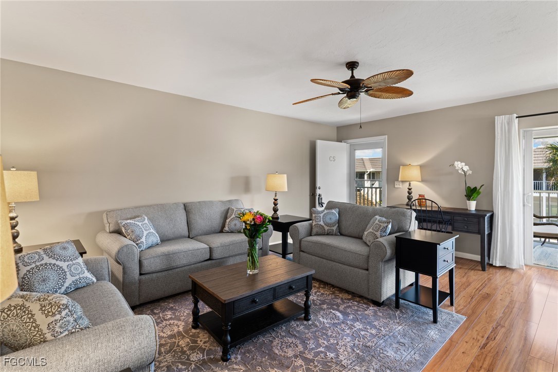 601 Periwinkle Way, Unit C5 Sanibel, FL 33957 - Photo 7 of 35 a living room with furniture a ceiling fan a lamp and a window