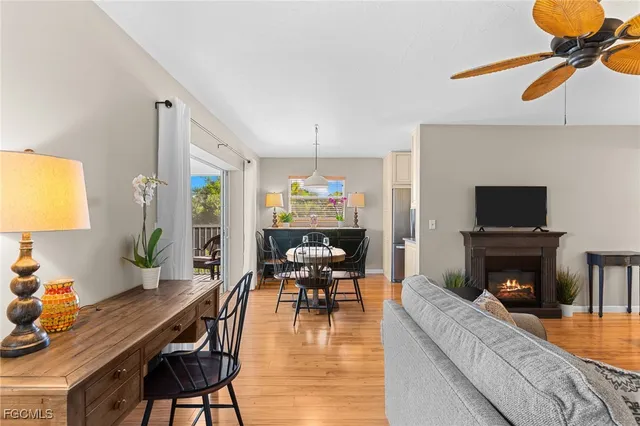 a dining room with furniture a chandelier and wooden floor