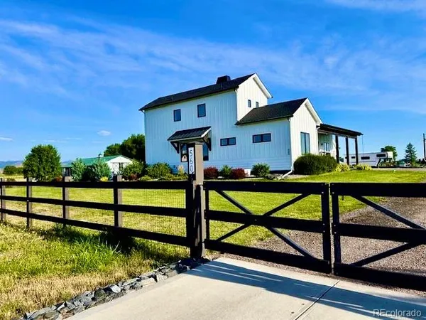 a front view of a house with porch and wooden floor