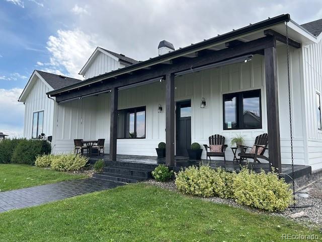 560 Talons Reach Run Berthoud, CO 80513 - Photo 2 of 43 a front view of house with yard outdoor seating and barbeque oven