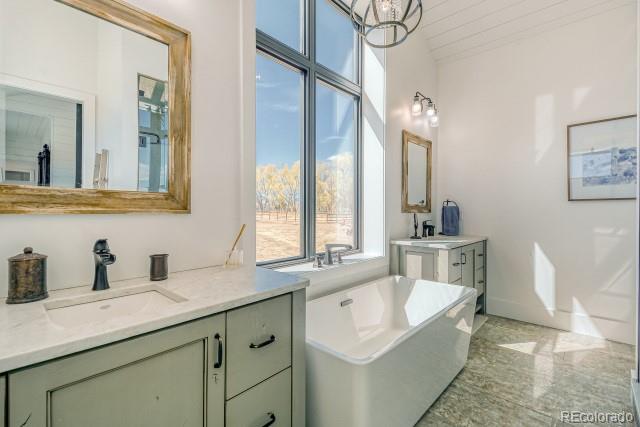 560 Talons Reach Run Berthoud, CO 80513 - Photo 22 of 43 a bathroom with a tub sink and mirror