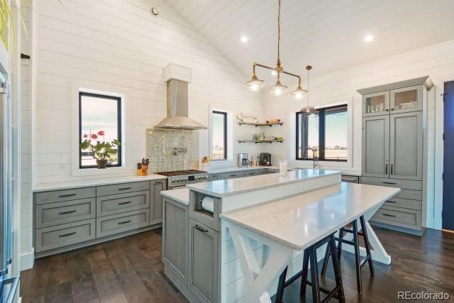 560 Talons Reach Run Berthoud, CO 80513 - Photo 7 of 43 a large kitchen with kitchen island a stove a sink a dining table and chairs