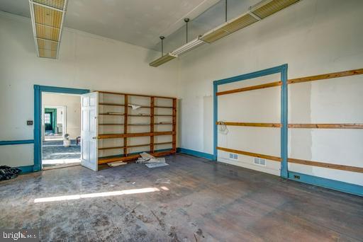 889 Butterfly Lane Frederick, MD 21703 - Photo 13 of 23 an empty room with sliding door and windows