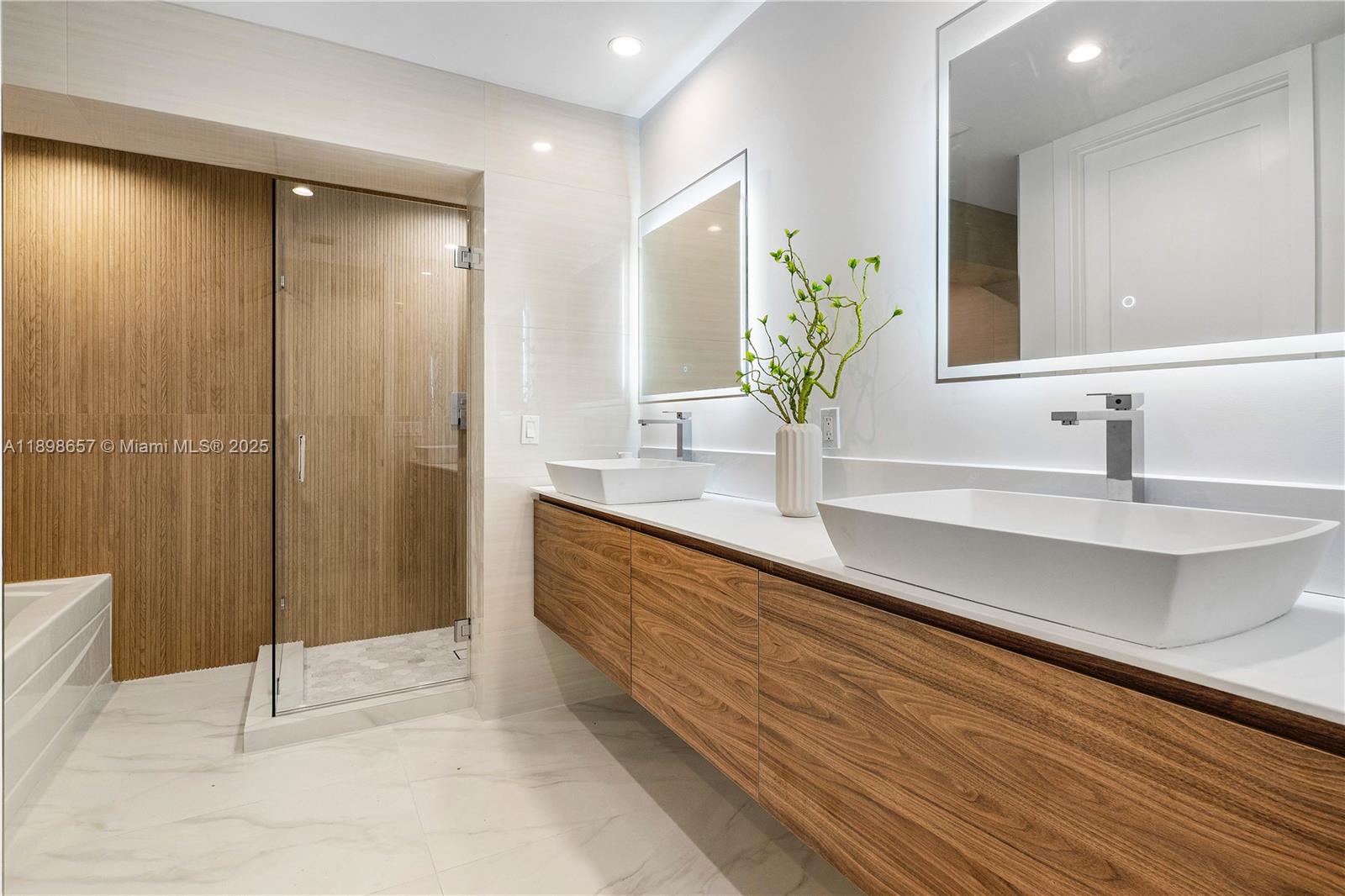 1338 Southwest 13th Street Boca Raton, FL 33486 - Photo 15 of 45 a bathroom with a double vanity sink and a mirror