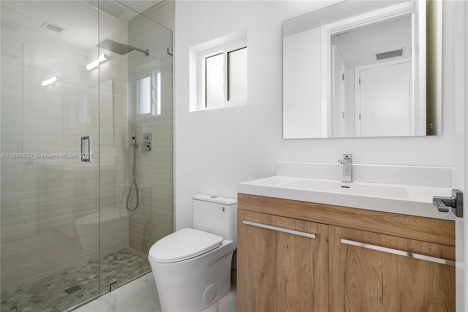 1338 Southwest 13th Street Boca Raton, FL 33486 - Photo 20 of 45 a bathroom with a sink toilet and shower