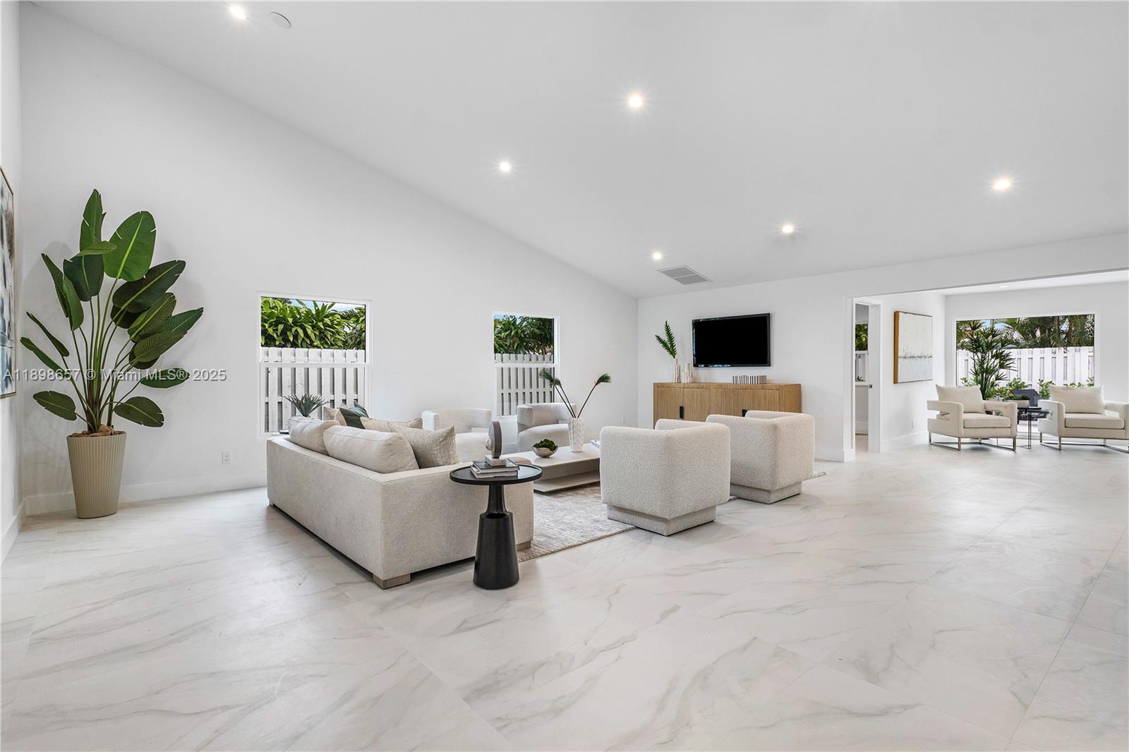 1338 Southwest 13th Street Boca Raton, FL 33486 - Photo 2 of 45 a living room with furniture and a flat screen tv