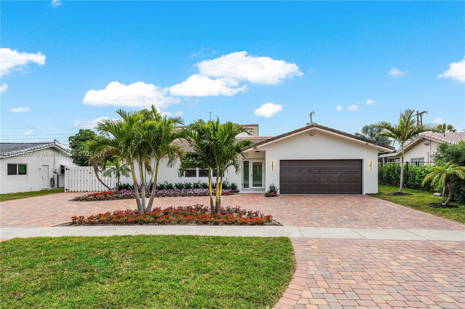 1338 Southwest 13th Street Boca Raton, FL 33486 - Photo 24 of 45 a front view of a house with a garden and yard