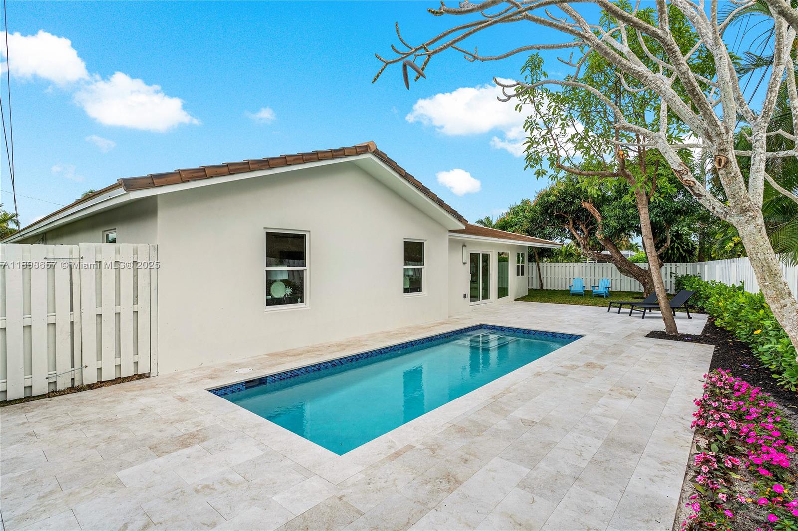 1338 Southwest 13th Street Boca Raton, FL 33486 - Photo 27 of 45 a view of backyard with swimming pool and seating space
