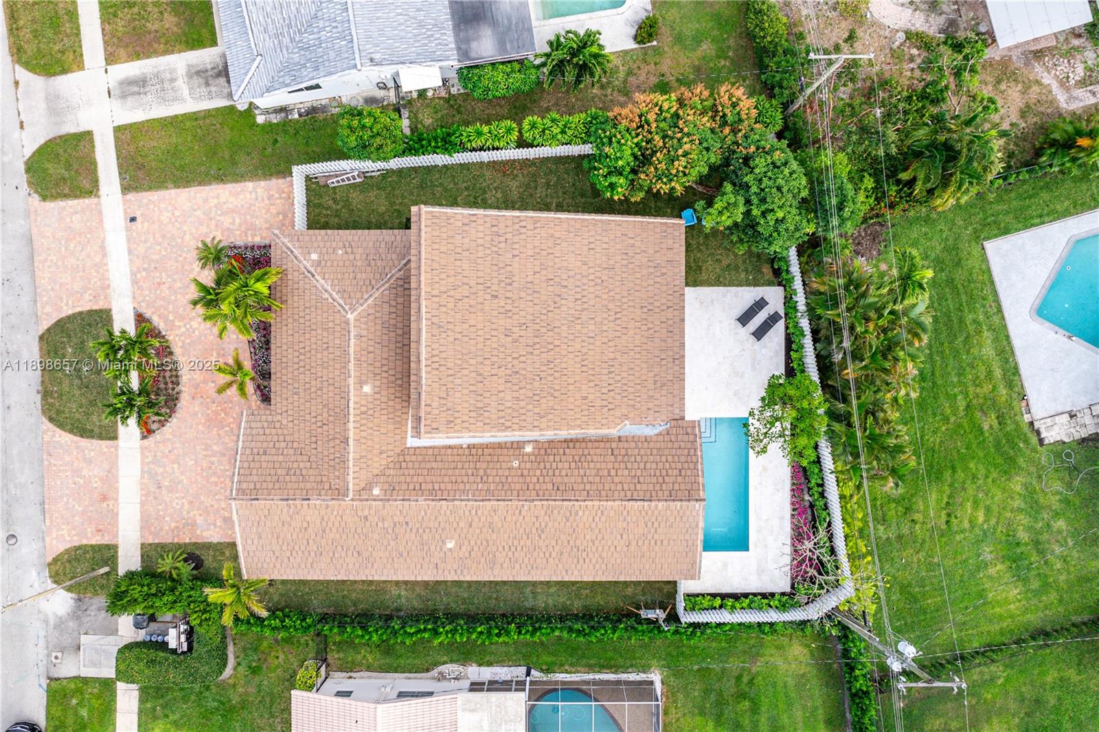 1338 Southwest 13th Street Boca Raton, FL 33486 - Photo 38 of 45 a front view of a house with a yard and fountain in middle