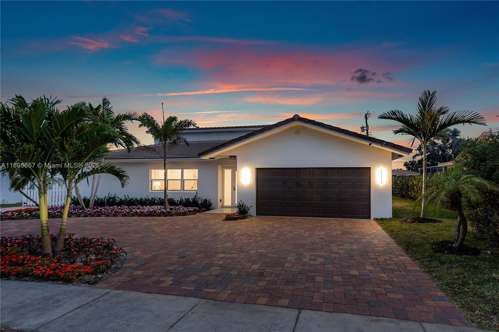 1338 Southwest 13th Street Boca Raton, FL 33486 - Photo 40 of 45 a front view of a house with a yard and garage