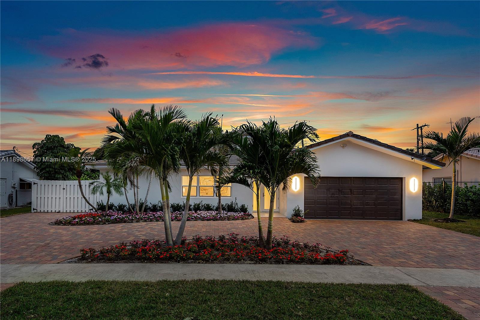 1338 Southwest 13th Street Boca Raton, FL 33486 - Photo 42 of 45 a front view of a house with a garden and yard