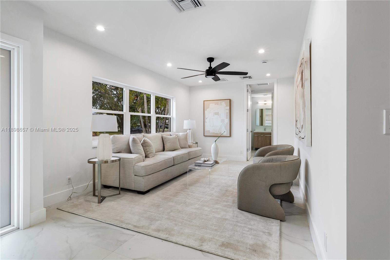 1338 Southwest 13th Street Boca Raton, FL 33486 - Photo 7 of 45 a living room with furniture and a ceiling fan