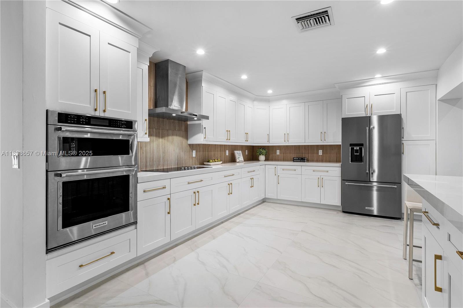 1338 Southwest 13th Street Boca Raton, FL 33486 - Photo 9 of 45 a kitchen with stainless steel appliances white cabinets and white appliances