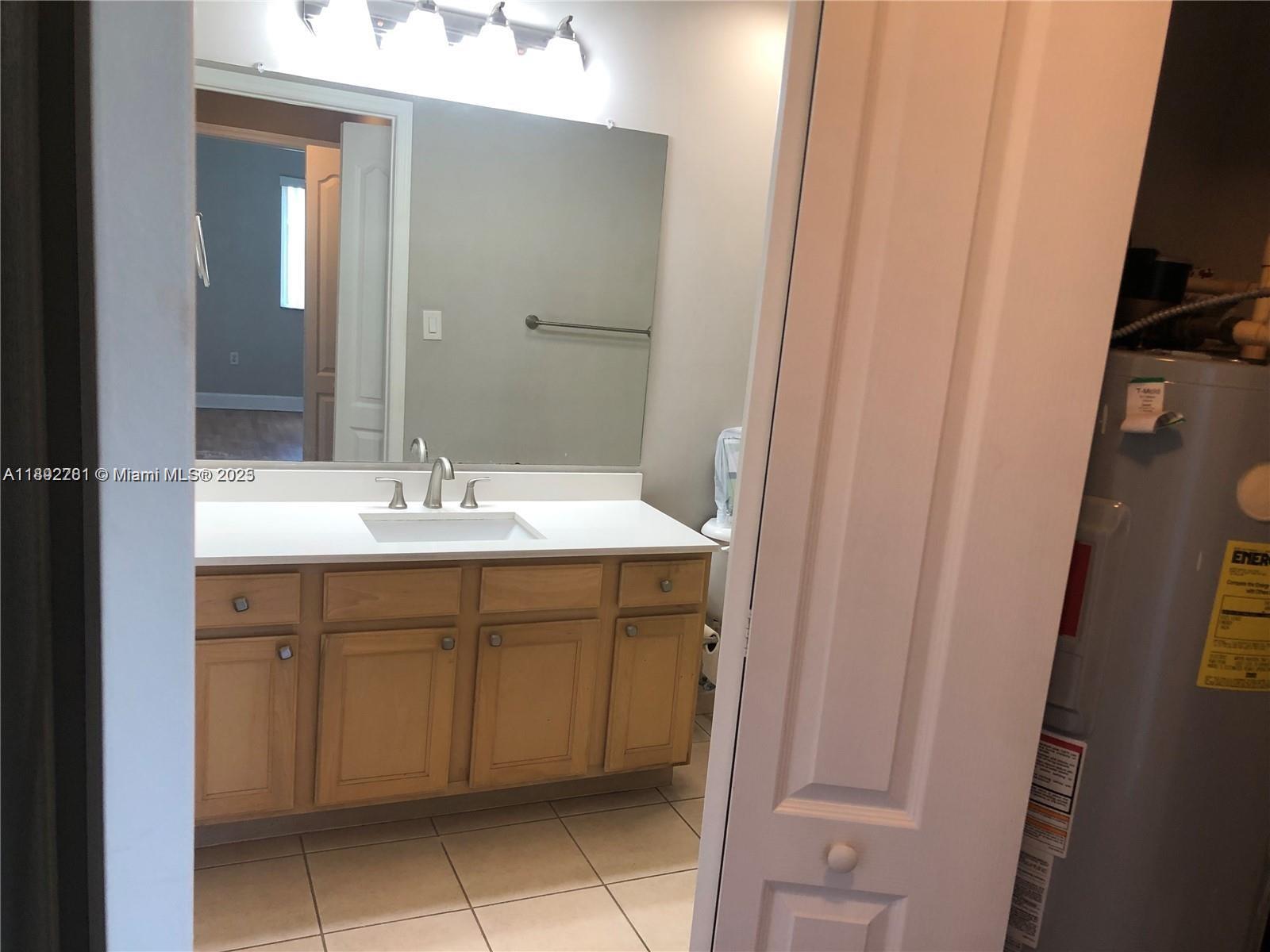 6001 Southwest 70th Street, Unit 528 South Miami, FL 33143 - Photo 14 of 21 a bathroom with a sink and a mirror