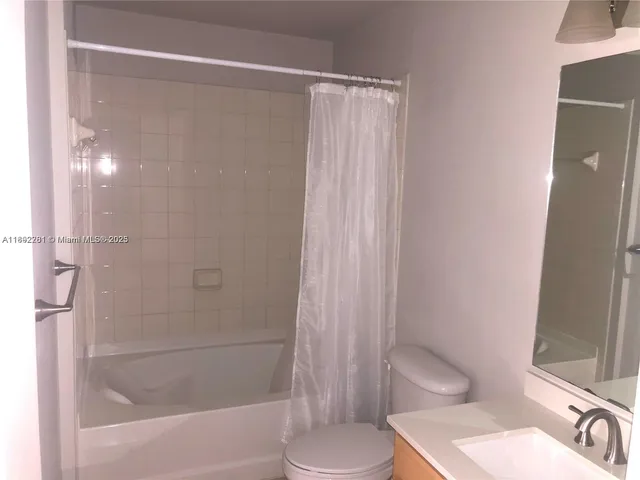 a bathroom with a shower and a toilet