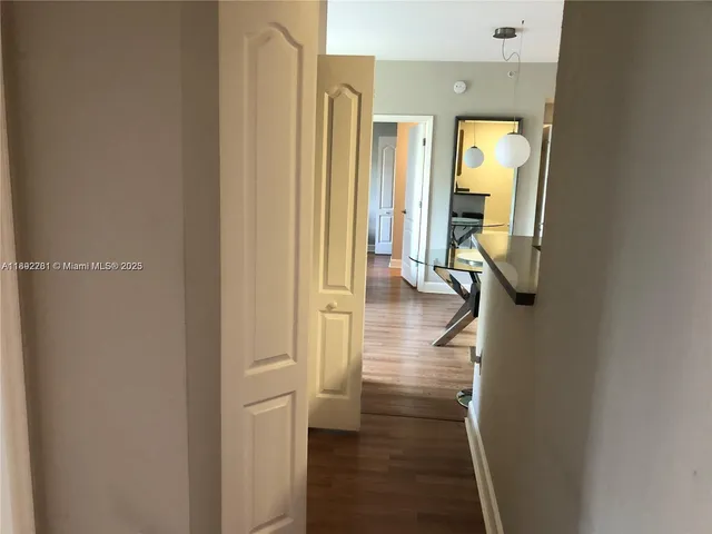 a view of hallway with livingroom and furniture
