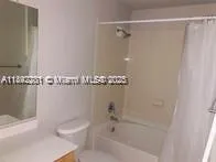 a bathroom with a shower and a toilet