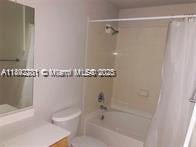 6001 Southwest 70th Street, Unit 528 South Miami, FL 33143 - Photo 18 of 21 a bathroom with a shower and a toilet