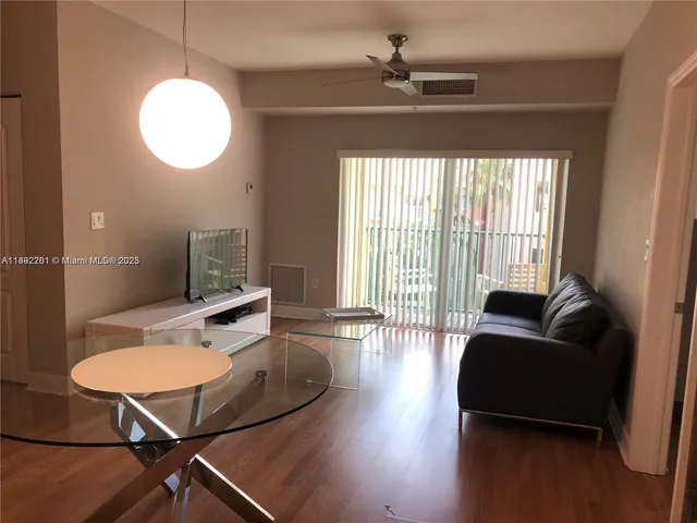 a living room with furniture and a window