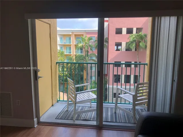 a view of a balcony with wooden floor