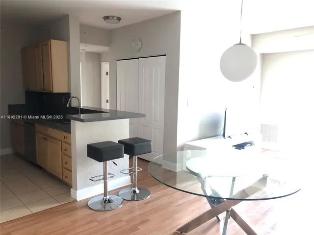 a kitchen with a dining table chairs and a stove