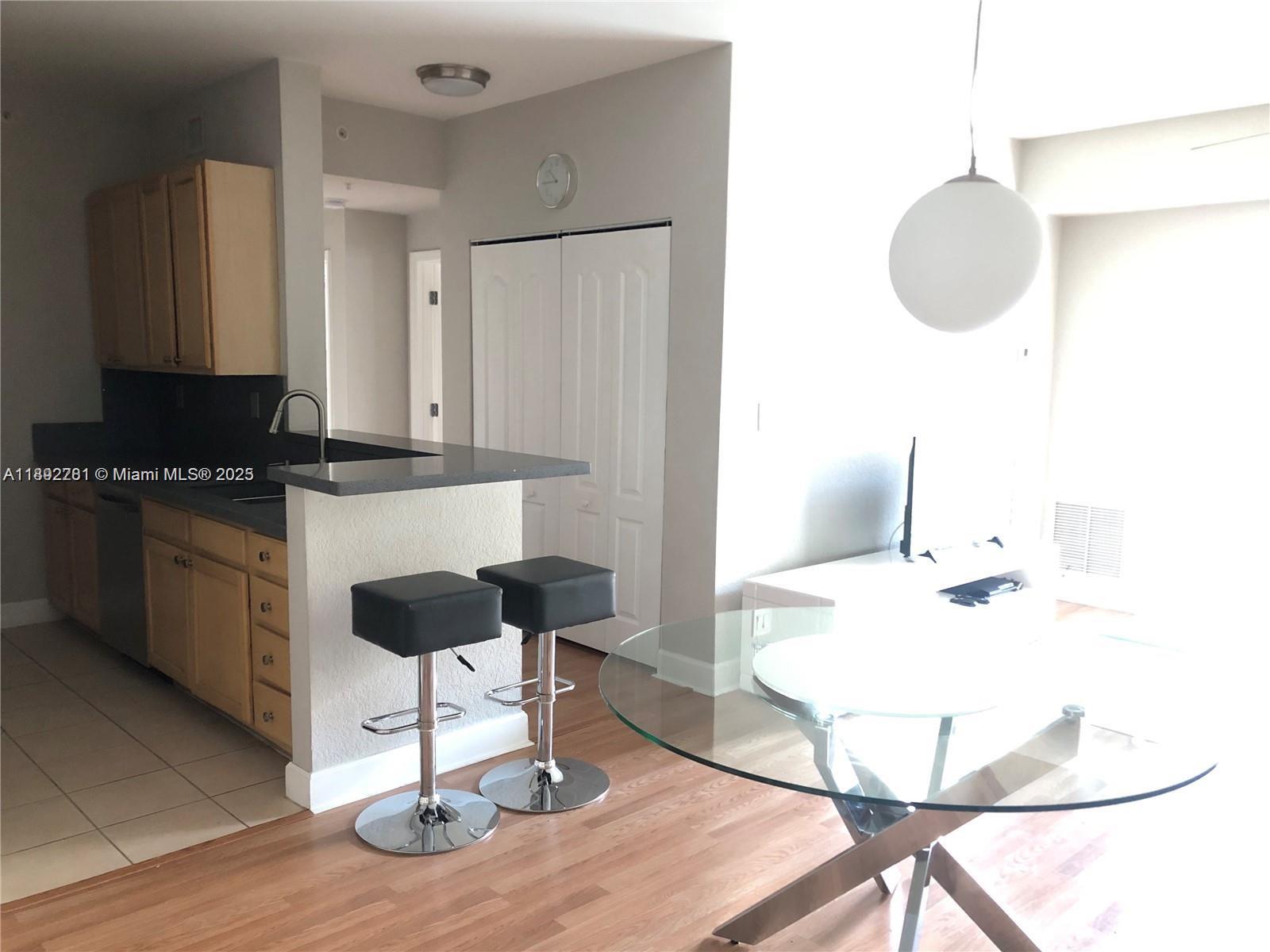 6001 Southwest 70th Street, Unit 528 South Miami, FL 33143 - Photo 8 of 21 a kitchen with a dining table chairs and a stove