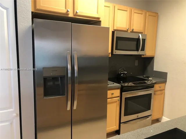 a stove top oven sitting inside of a kitchen
