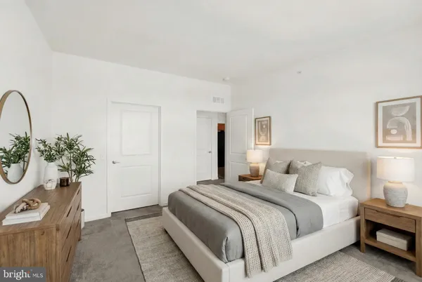 a bedroom with a bed and a potted plant