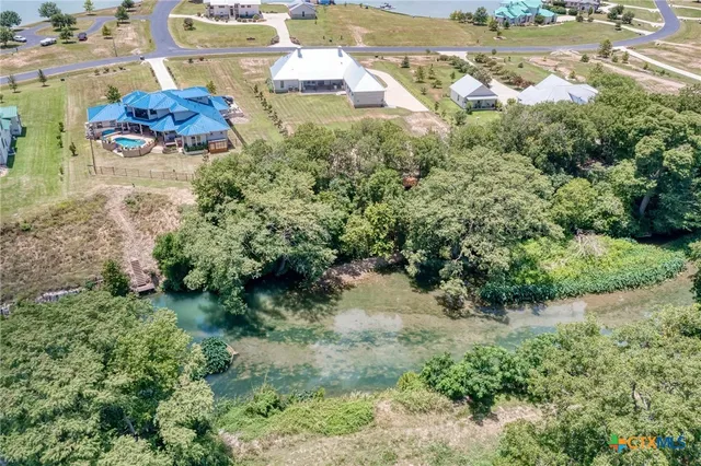 an aerial view of a house with a yard