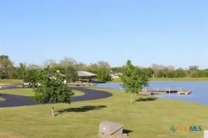 a view of a lake with a yard