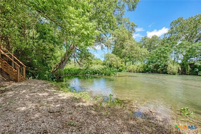a view of a lake with houses in the back