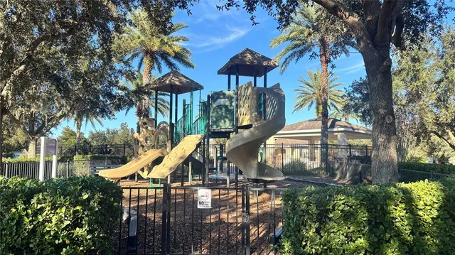a view of a park with iron fence