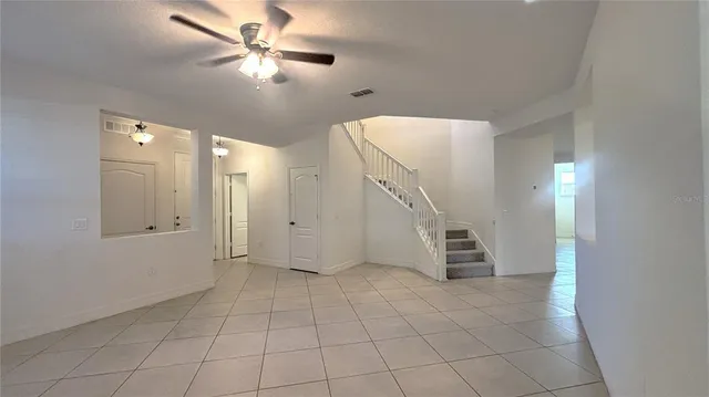 a view of an empty room with a fan