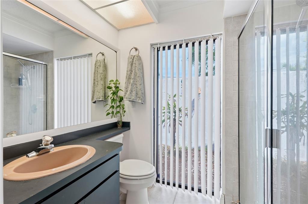 3927 Country View Lane Sarasota, FL 34233 - Photo 17 of 48 a bathroom with a double vanity sink toilet and shower