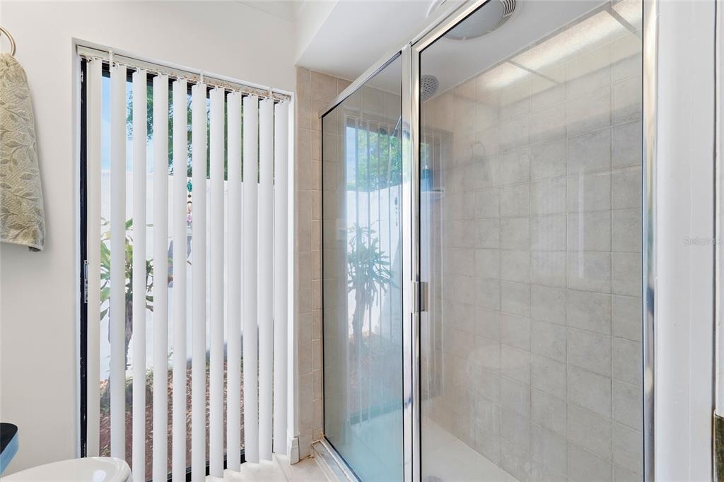3927 Country View Lane Sarasota, FL 34233 - Photo 18 of 48 a bathroom with a glass shower door