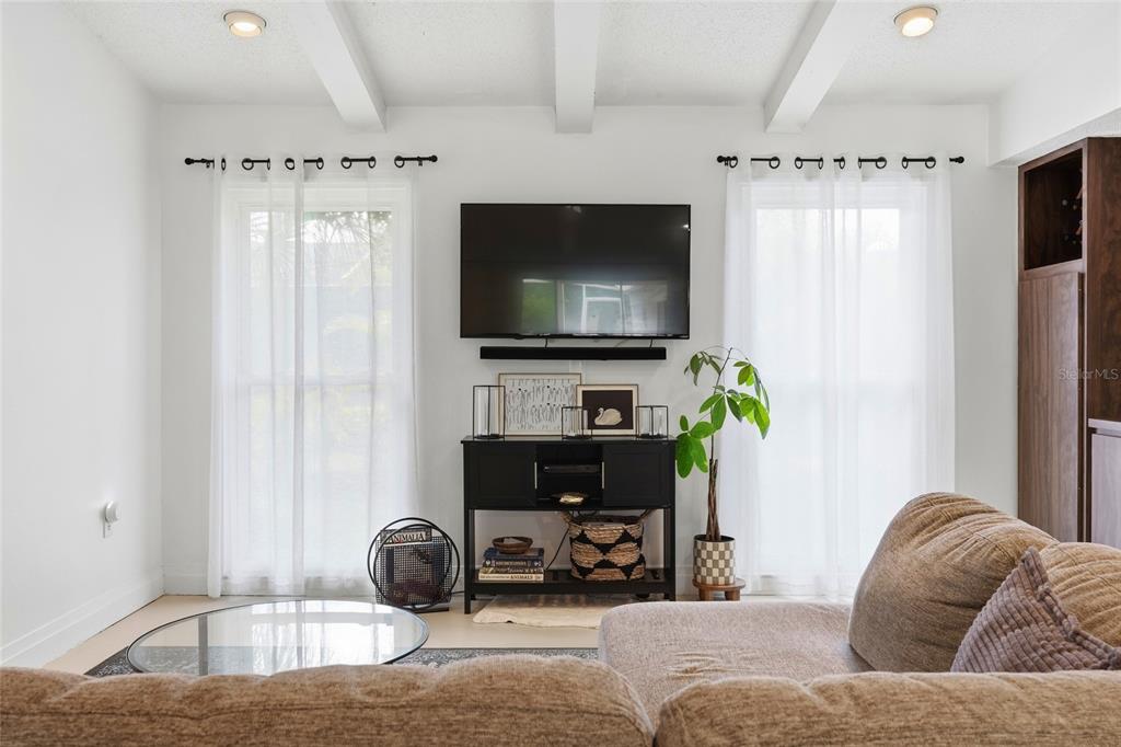 3927 Country View Lane Sarasota, FL 34233 - Photo 23 of 48 a living room with furniture and a flat screen tv