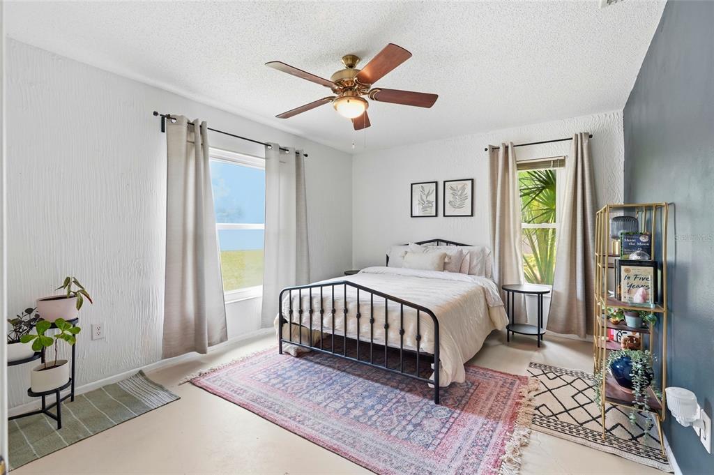 3927 Country View Lane Sarasota, FL 34233 - Photo 30 of 48 a bedroom with a large bed dresser and a window