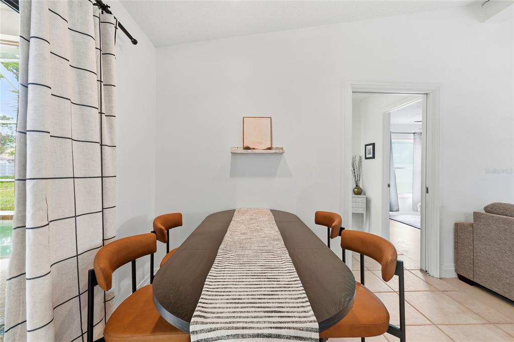 3927 Country View Lane Sarasota, FL 34233 - Photo 32 of 48 a balcony with table and chairs