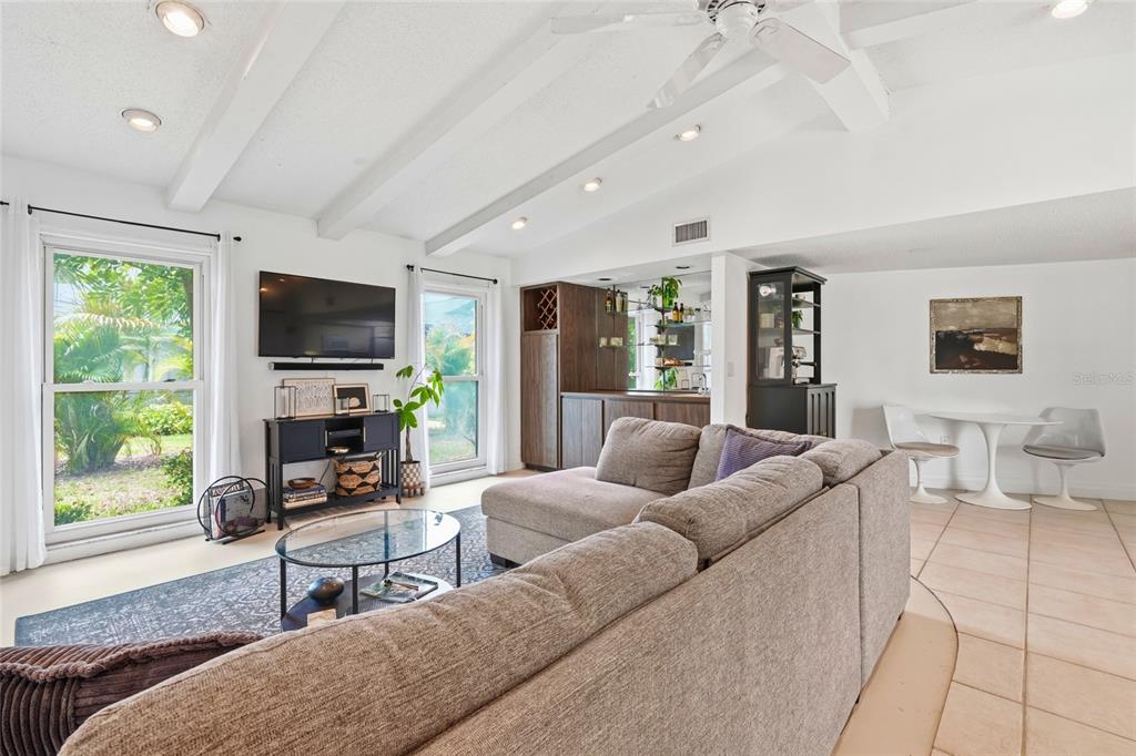 3927 Country View Lane Sarasota, FL 34233 - Photo 33 of 48 a living room with furniture a flat screen tv and a fireplace