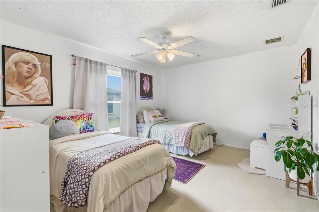 3927 Country View Lane Sarasota, FL 34233 - Photo 37 of 48 a bedroom with a bed and a painting on the wall