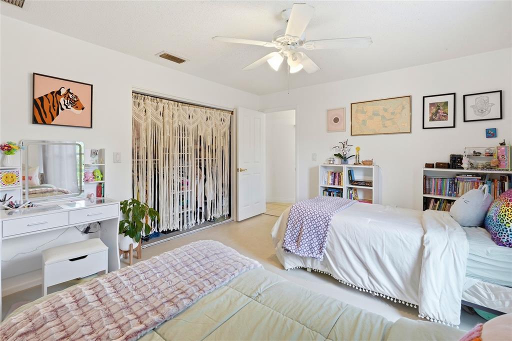 3927 Country View Lane Sarasota, FL 34233 - Photo 38 of 48 a bedroom with a large bed and a chandelier